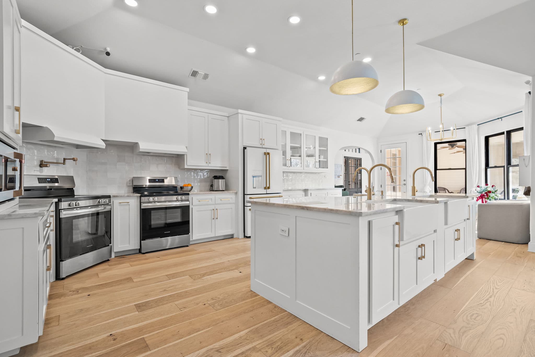 Chef's kitchen with a marble-topped island and double range